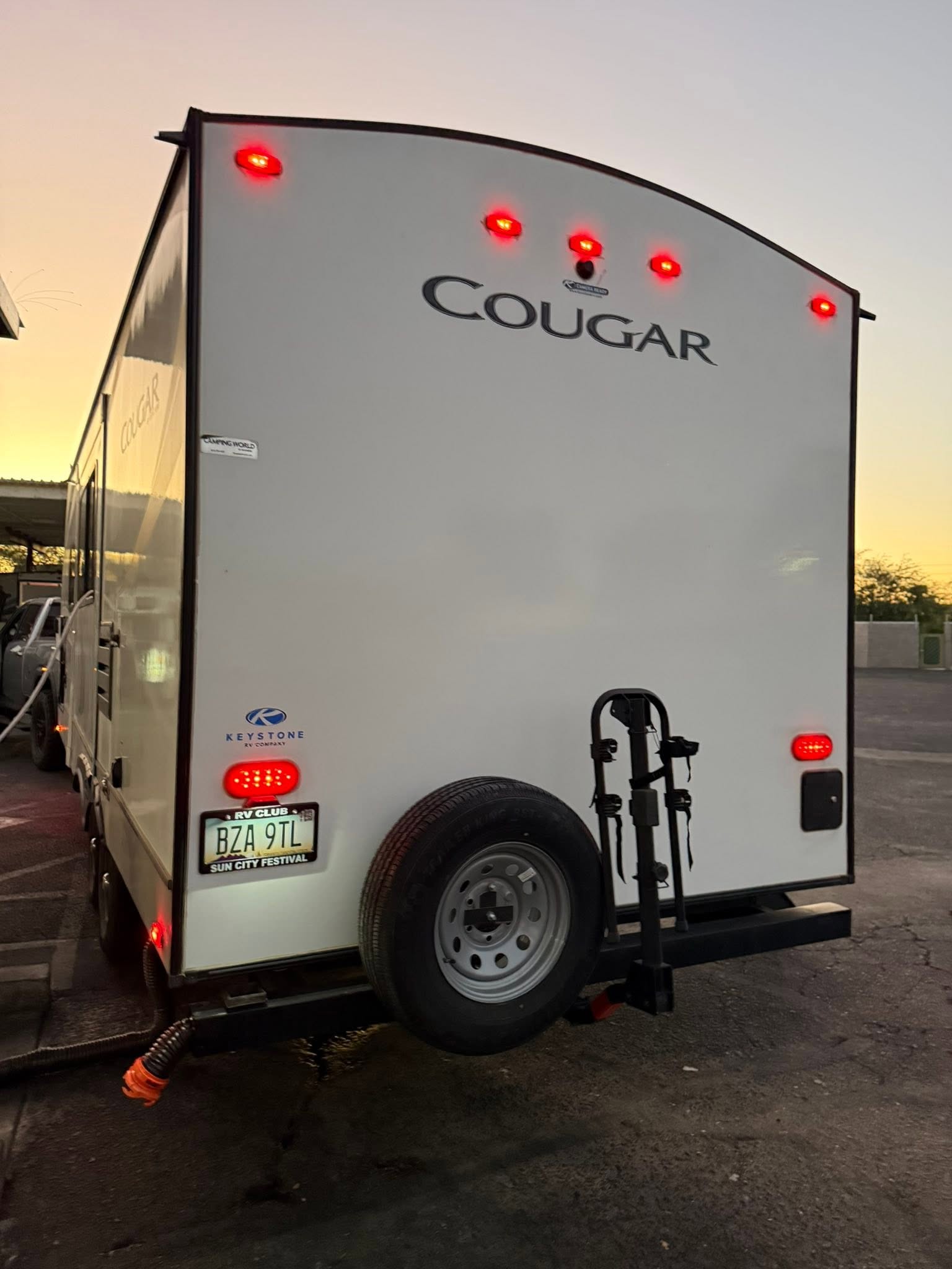 Keystone Cougar rear exterior with the spare tire and bike rack
