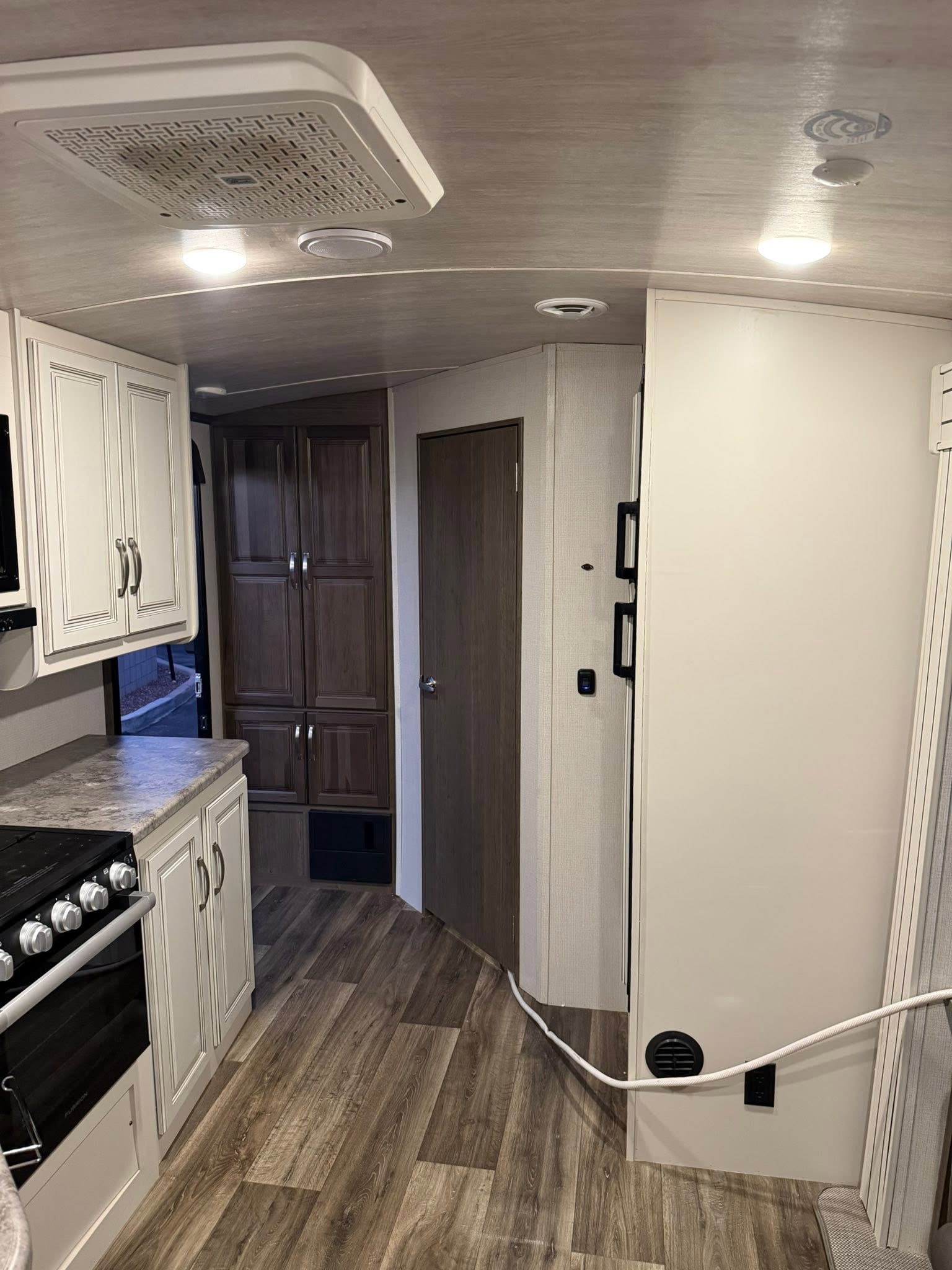 Keystone Cougar kitchen with the range, counter, and refrigerator